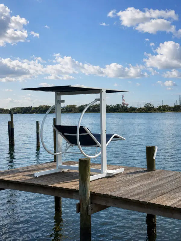 David Frank Furniture Zero Gravity Swing overlooking the ocean at sunset